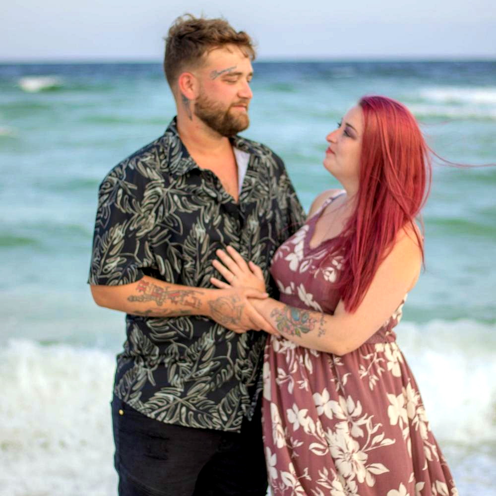 Lexi and Cody standing by the ocean